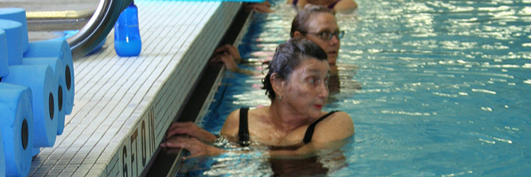 group of adults taking swim lessons