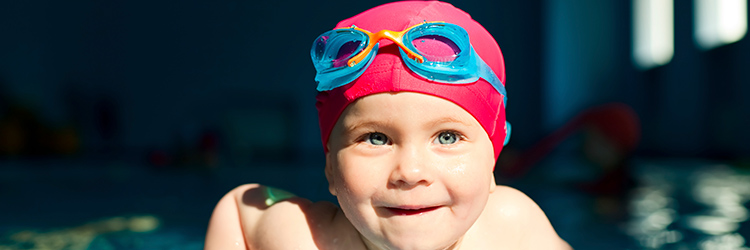 Child in swimming cap with goggles